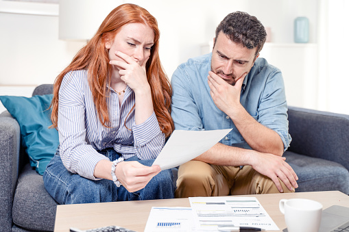 Young caucasian couple having debt problems after home expenses