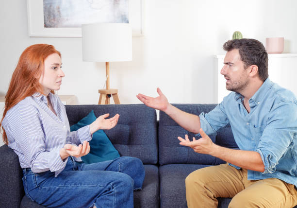 istock Upset and sad couple arguing with each other on sofa 1410990265