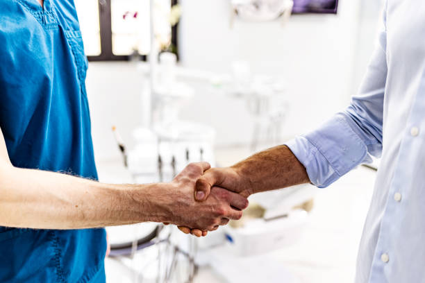istock Businessman and doctor shaking hands 1410991076