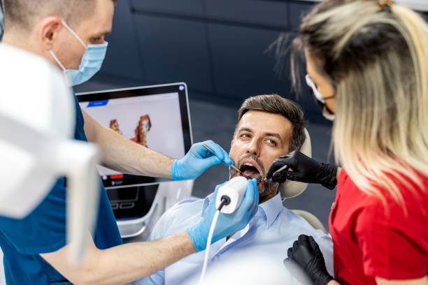 istock Dentist explaining results to a male patient 1410991185