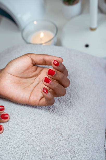 istock Close up of female hands having manicure treatment 1410991973