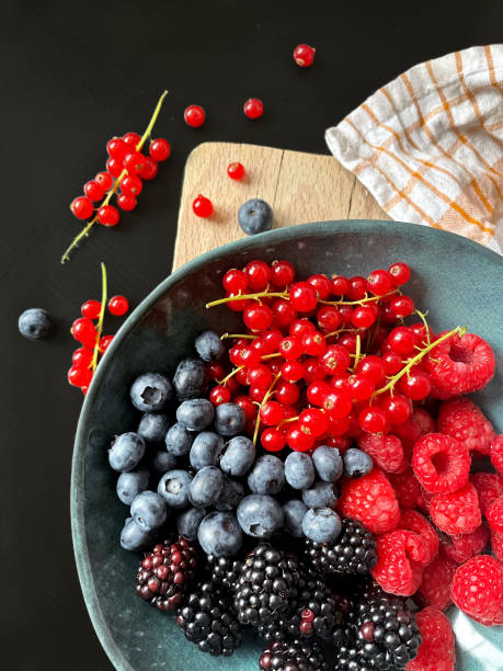 istock strawberries and blueberries, blackberries and red currant in a bowl 1410994805