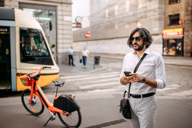 Handsome businessman using phone in the city