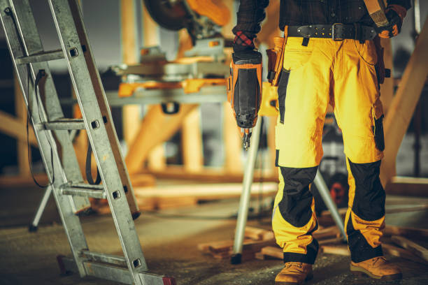 Construction Contractor Worker with a Nail Gun in His Hand stock photo