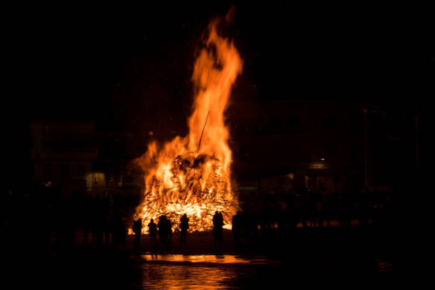 istock Silhouette of people watching a big bonfire 1410997474