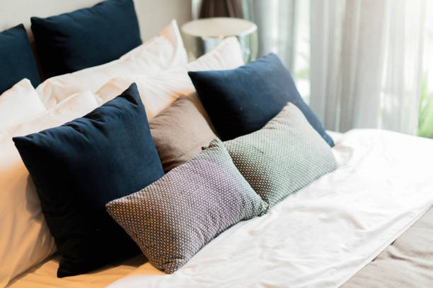 istock bedroom interior design close up,home interior concept soft pillow arrange on king size white blanket mattress in bedroom with white curtain background home sweet home interior ideas 1410997570