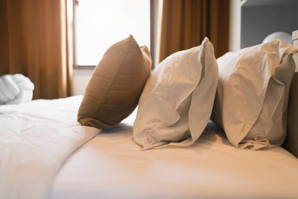 istock bedroom interior design close up,home interior concept soft pillow arrange on king size white blanket mattress in bedroom with white curtain background home sweet home interior ideas 1410997706