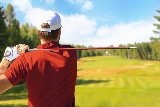 istock Athletic young man playing golf in golfclub. 1410998025