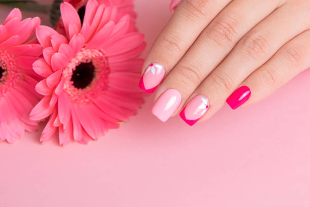istock Female hands with pink manicure, flowers design 1410998026
