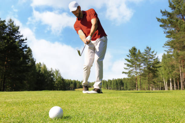 istock Athletic young man playing golf in golfclub. 1410998082
