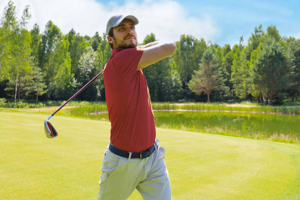 istock Golfer hitting golf shot with club on course while on summer vacation. 1410998113