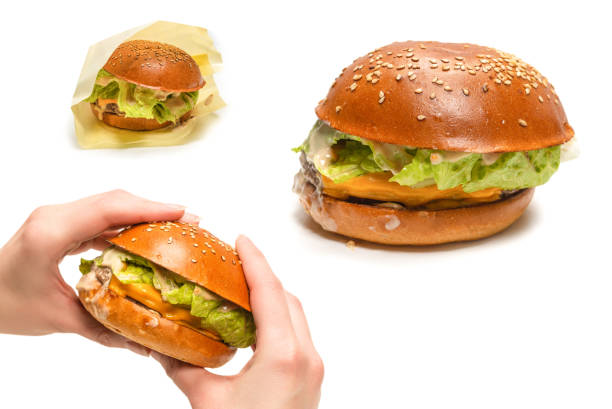 istock Hamburger in woman hands isolated on a white background. 1410998156