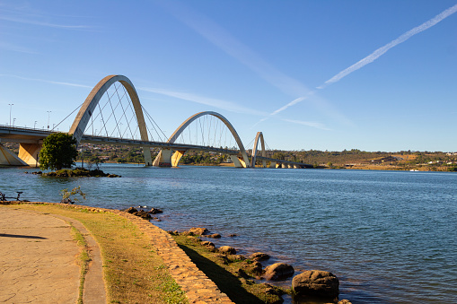 Brasília, Federal District, Brazil – July 24, 2022:   A landscape with Juscelino Kubitschek Bridge (JK Bridge) and Paranoá Lake and blue sky in the background. It is located in Brasília and is a work of the architects Alexandre Chan and Mário Vila Verde.