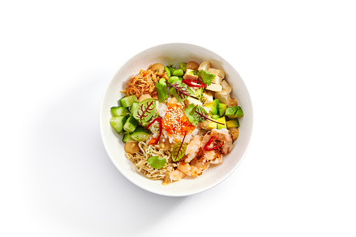 Poke with shrimp, avocado and seasonings. Traditional hawaiian cuisine. Tasty polynesian dish served with tofu cheese. Delicious salad with rice, edamame and soybean. Food composition