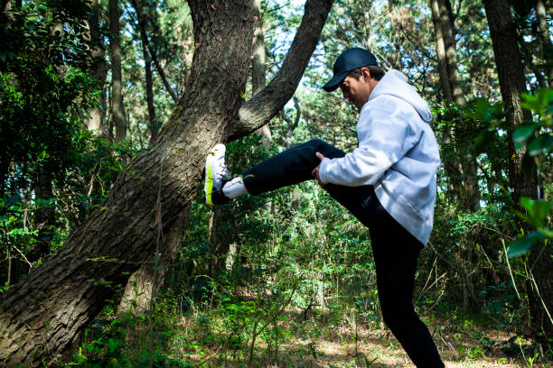 istock Man stretching in the forest 1410999365