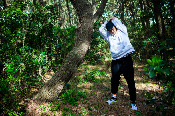 istock Man stretching in the forest 1410999368