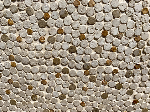 texture, background. small round stones of gray color, with small green inclusions. voluminous texture with natural stone.