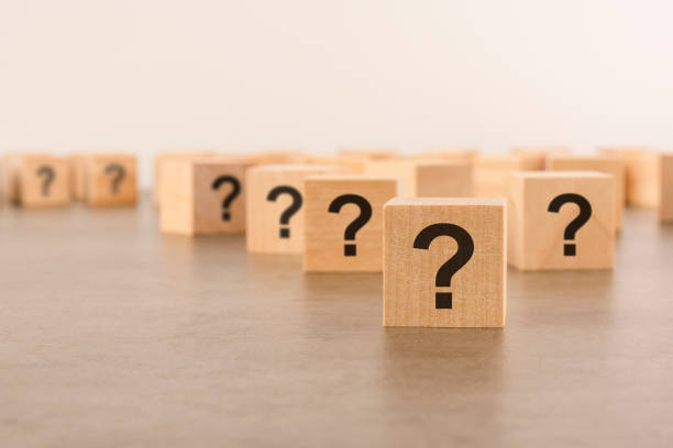 istock front view on many wood cubes with question marks. many question arising concept 1411000849