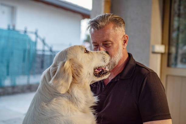 istock Mature Man Working on Friendship with His Beloved Dog 1411001129