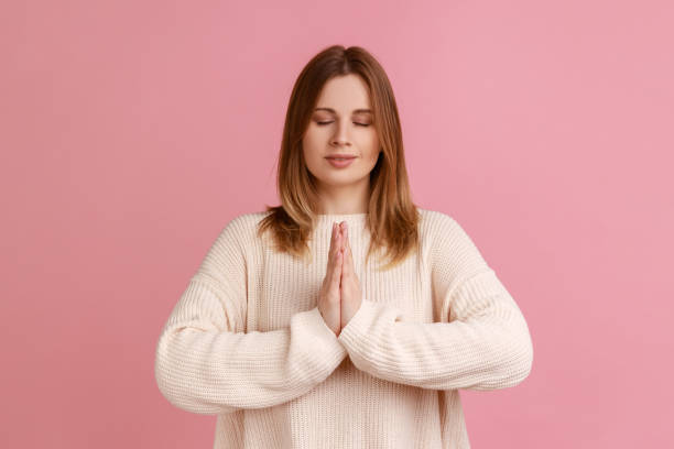 istock Woman keeping palms together, doing yoga exercise breath technique reduce stress. 1411001790