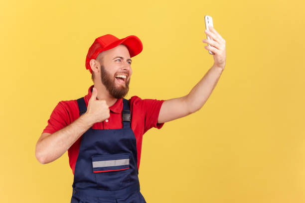 istock Worker taking selfie or talking on video call, looking at device camera, showing thumb up to client. 1411001807