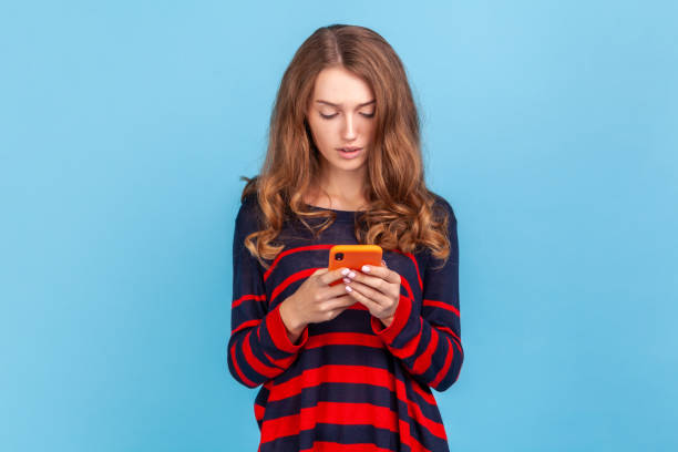 istock Concentrated woman using smart phone, typing message or checking social networks, writing post. 1411001875