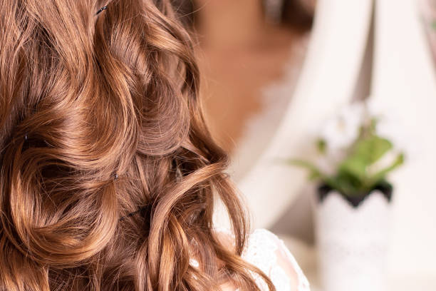 istock Female back with long curly blonde hair 1411002115
