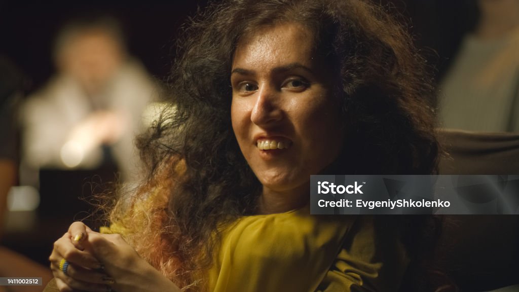 Disabled woman in the group of actors Happy actress with disability in a wheelchair smiling and looking at the camera while sitting together with a cast of actors in the theater 35-39 Years Stock Photo