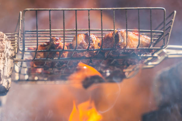istock Delicious juicy meat on a grill is fried on a fire 1411002713