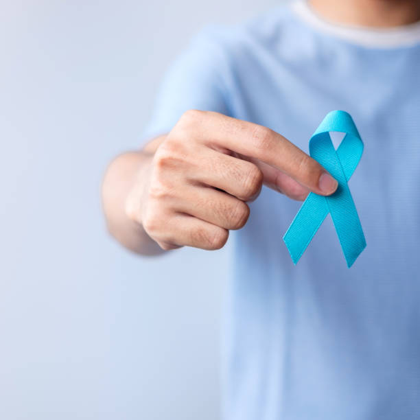 blue november prostate cancer awareness month, man in blue shirt with hand holding blue ribbon for support people life and illness. healthcare, international men, father, diabetes and world cancer day - november imagens e fotografias de stock