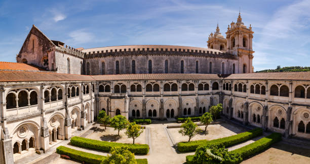 Panorama of the church and cloister of the monastery complex of Mosteiro de Alcobaca, Portugal The Church and Crucifix of the World Heritage Monastery of Saint Mary of Alcobaca, Portugal batalha abbey photos stock pictures, royalty-free photos & images