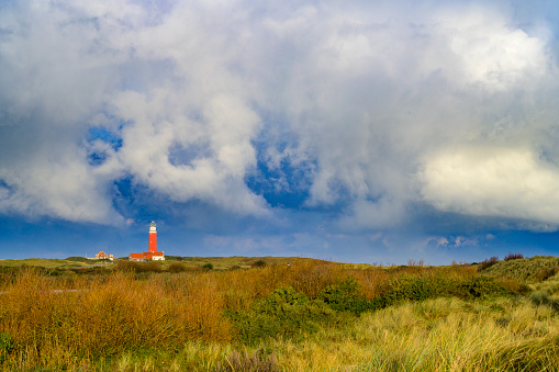 Lighthouse at the Wadden island Texel in the dunes with during a stormy autumn morning. The Eierland lighthouse is located at the North point of the island.