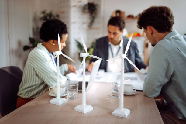 istock Group of eco engineers working on a wind turbine project in the office 1411004661