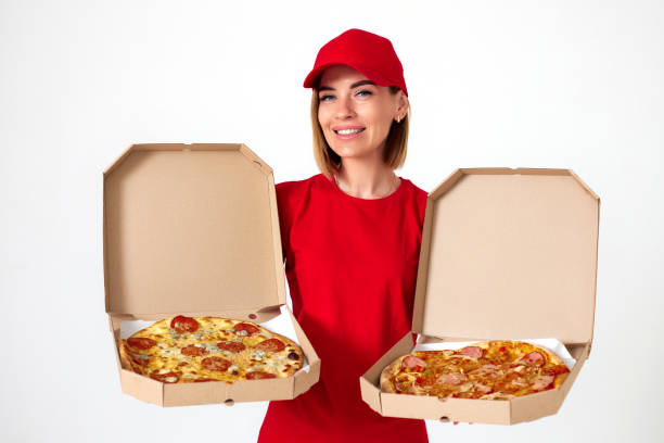 istock pizza delivery girl showing pizza inside boxes 1411004834
