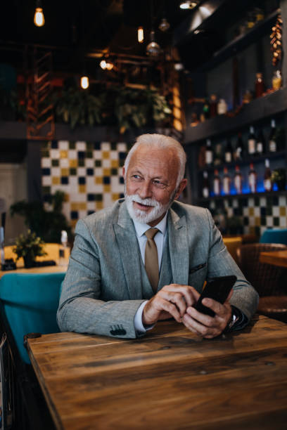 istock Senior businessman sitting in restaurant 1411005442