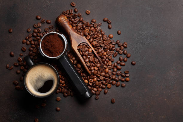 istock Roasted coffee beans and ground coffee in filter holder 1411006402