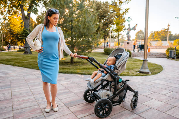 istock Young Mother Having A Walk Through The Park With Her Baby 1411006782