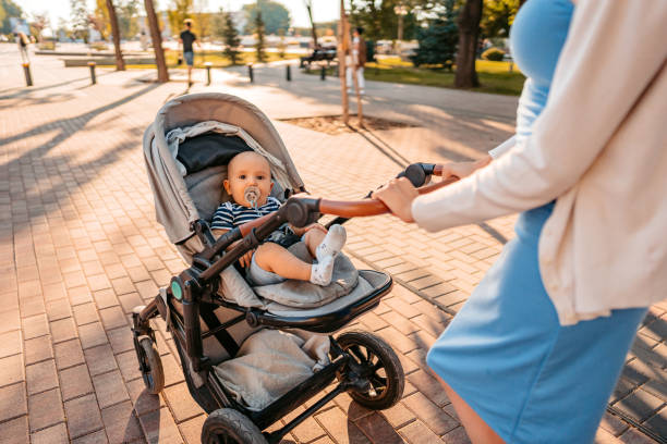 istock Young Mother Having A Walk Through The Park With Her Baby 1411006810