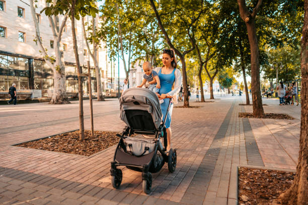 istock Young Mother Having A Walk Through The Park With Her Baby 1411006865
