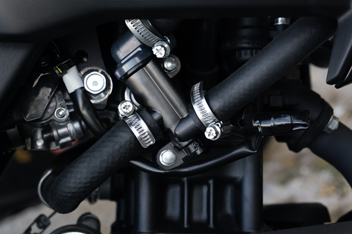 Dark metal motorcycle parts and tubes close-up view
