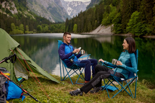 istock An adventurous young couple at their campsite drinking coffee 1411008733