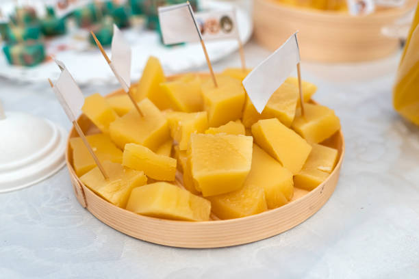 pieces of hard yellow cheese on a stick for taste testing.