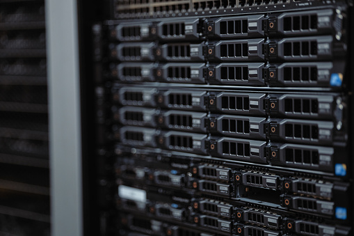 Closeup of an IT server mainframe in a data centre. Uploading data protection and storage software, a malware system, a coding interface for maintenance and computing code for information security