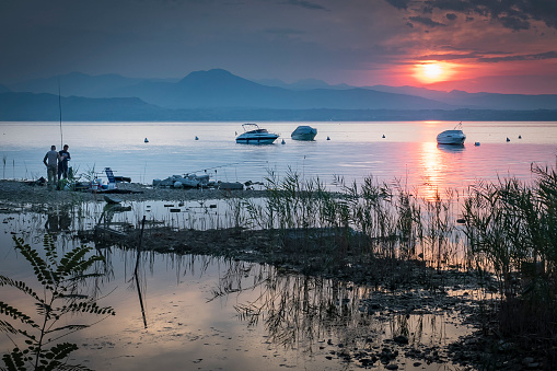 Garda Lake's water level during summer 2022 is very low, so new places for fishing can be found.