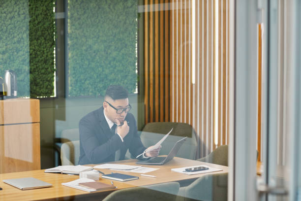 istock Successful Asian Businessman in Glass Office 1411010089