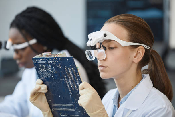 istock Female Engineer Inspecting Tech Parts 1411010305
