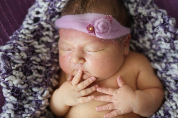 istock newborn baby sleeping in bandage in  basket 1411011226