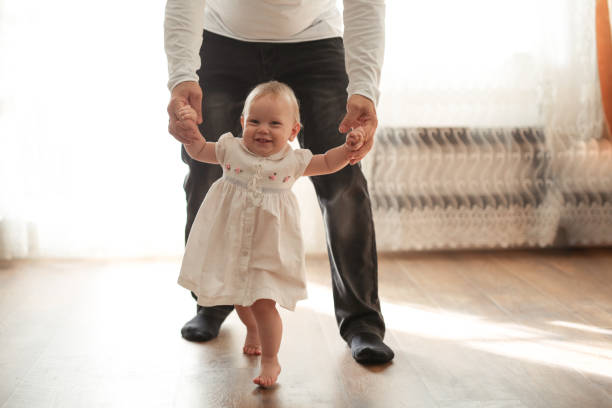 istock Father and his daughter child girl first step 1411011514