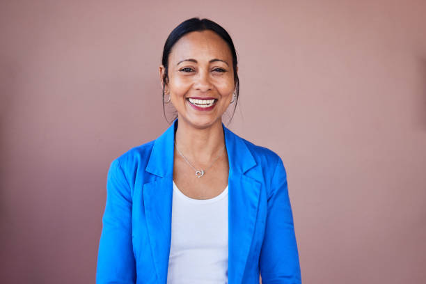 istock Mature businesswoman laughing while standing by an office wall 1411012186