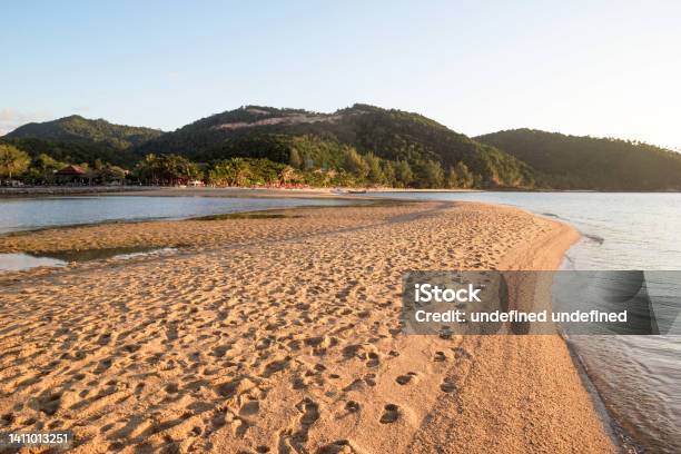 Sandy Beach On Coastline Near To Sea And Mountains At Sunset Stock Photo - Download Image Now